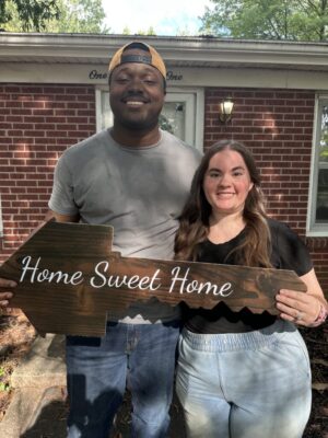 Happy buyers in front of their new home in Winston Salem, NC